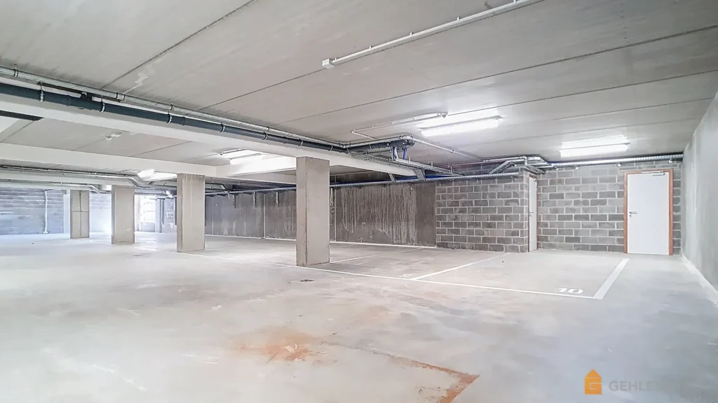 Parking intérieur de la Résidence Les Abords du Lac à Robertville